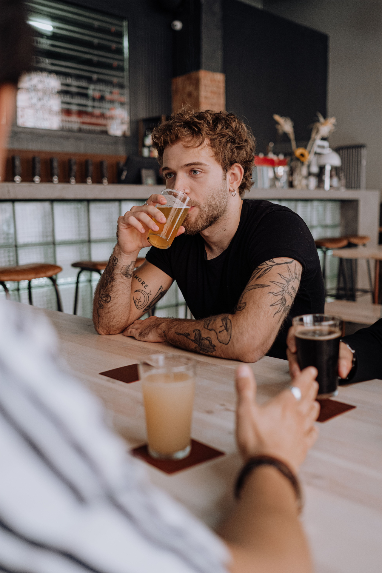 Mates sharing a beer at a Melbourne bar